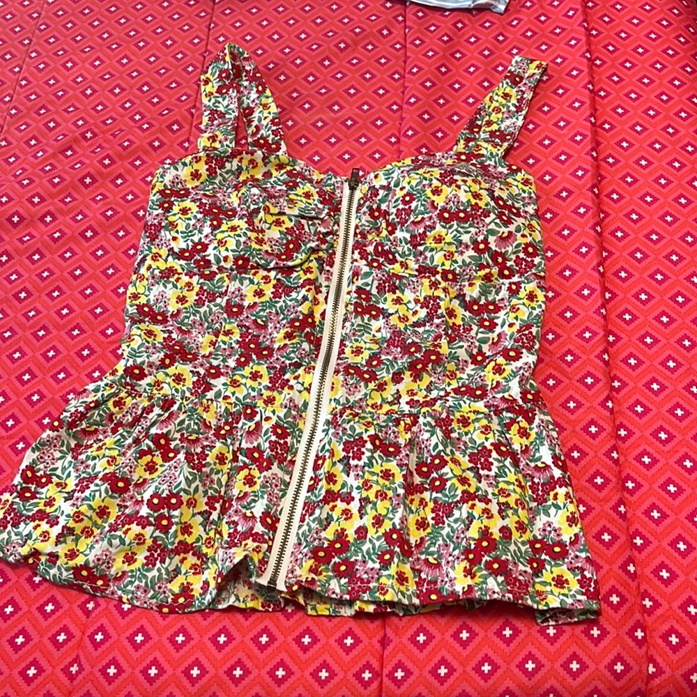 T- shirt is flower print . Size is small and brand is liberty love.